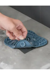 Silicone drain hair catcher detail view showing suction cup and flexible material function.
