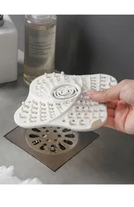 Silicone hair catcher drain protector detail view showing anti-clogging pins and drainage holes.