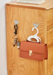 Multifunctional bag hook for closet storage, portable handbag holder and strap hanger.