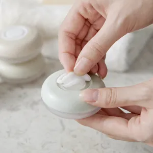 Portable press-type travel cosmetic lotion container and cream dispenser box for daily use.