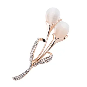 Close-up detail of elegant rose gold tulip brooch with opal buds and sparkling rhinestones.