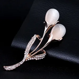 Elegant rose gold tulip brooch featuring glowing cat eye stone and sparkling crystal rhinestones.