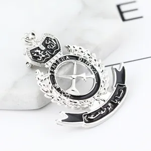 Close-up of a vintage military style alloy brooch featuring black enamel and retro lapel pin design.
