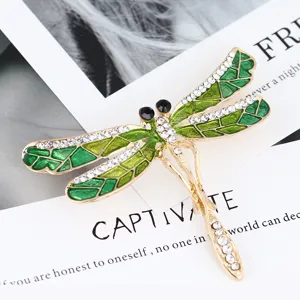 Elegant green enamel dragonfly brooch with sparkling rhinestones, perfect for coats and sweaters.