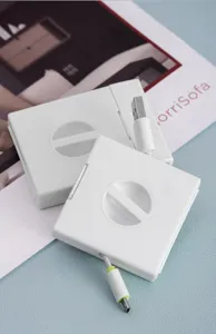 Détail de boîte de rangement de câble portable, enrouleur de cordon blanc et organisateur.