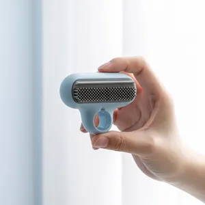 Mini T-shaped glass cleaning brush with silicone bristles and finger ring for mirror.