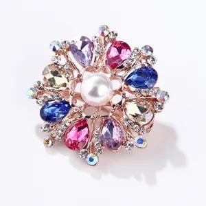 Close-up detail of a colorful crystal pearl flower brooch, sparkling rhinestone alloy jewelry.