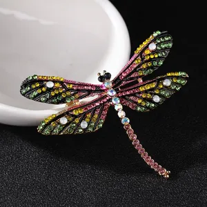 Detailed shot of a vintage multi-color rhinestone dragonfly brooch pin, elegant insect jewelry.
