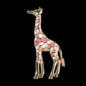 Elegant gold-tone giraffe brooch with pink and white enamel details, perfect accessory.
