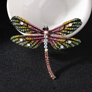 Colorful rhinestone dragonfly brooch detailed shot, vintage enamel insect pin jewelry accessory.