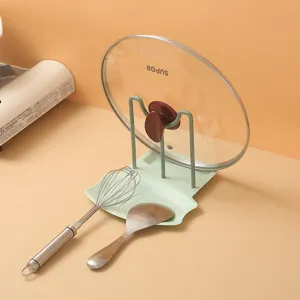 Multi-functional kitchen pot lid holder organizer rack with utensil rest for space saving.