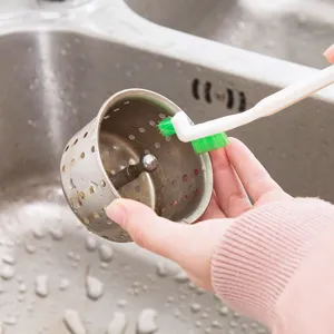 Multipurpose gap cleaning brush for tight spaces, household cleaning tool in kitchen use view.
