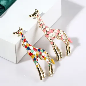 Exquisite colorful enamel giraffe brooch detail, elegant animal design metal pin accessory.