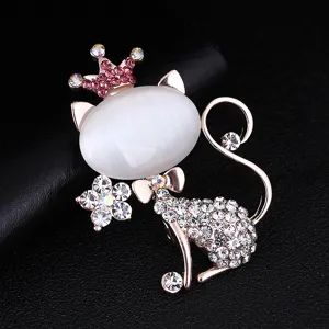 Detailed view of the elegant rhinestone crown cat brooch, sparkling crystals and opal stone.