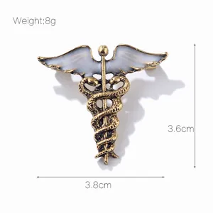 Broche Caduceo vintage de aleacion esmalte blanco alas de angel simbolo medico insignia