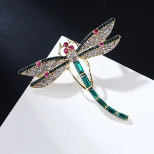 Detailed close-up of a stunning rhinestone dragonfly brooch with sparkling crystals and gems.
