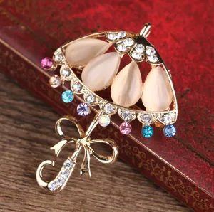 Elegante spilla ad ombrello con pietra occhio di gatto e strass con fiocco accessorio moda donna