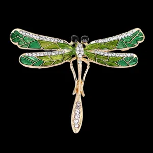 Elegant green enamel dragonfly brooch with sparkling crystal rhinestones and gold tone.