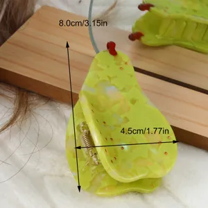 Close-up view of the pear-shaped green acetate hair claw clip, highlighting its unique glossy design.