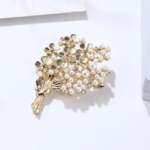 Close-up detail of the elegant gold bouquet pearl brooch showcasing fine metalwork and gems.