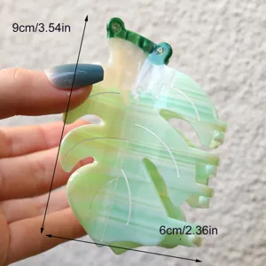 Detail view of the cute green frog leaf acetate hair claw clip, showing dimensions clearly.