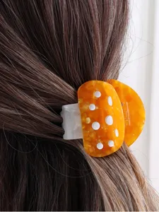 Detailed shot of the cute mushroom acetate hair claw clip, showing its unique spotted design.