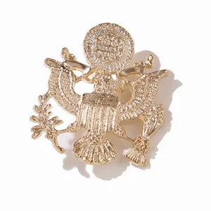 Close-up detail view of the golden eagle brooch, featuring metallic relief craft.