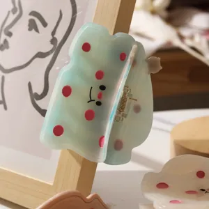 Süßes Acetat-Haarklammer-Detail mit niedlichen Punkten und einem netten lächelnden Gesicht.