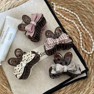 Small hair claw clip set with cute bows, perfect for half-up hairstyles and thin hair styling.