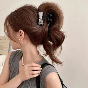 Small bow hair claw clip for women, sweet pony tail holder, trendy hair styling accessory.