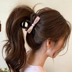 Pink bow hair claw clip detail, elegant large shark clip for thick hair styling accessories.