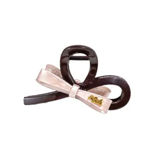 Large pink bow hair claw clip for women, elegant shark clip for thick hair styling accessories.