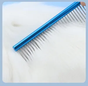 Closeup of blue aluminum pet grooming comb with fine stainless steel teeth on white fur.