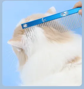 Blue metal pet grooming comb with dense and sparse teeth used on long hair cat safely.