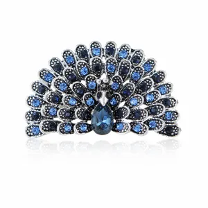 Close-up detail van vintage pauw broche met sprankelende blauwe strass steentjes en zilveren legering.