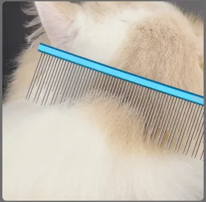 Close-up detail of a metal pet grooming comb with a blue handle, perfect for cat and dog fur.
