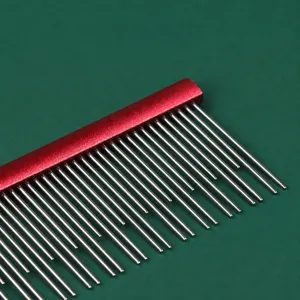 Professional pet grooming comb with rounded metal teeth and red handle for dogs and cats.