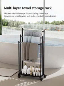 Detail view of the black metal multi layer rolling towel storage rack in modern bathroom.