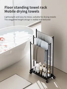 Detail view of the black metal floor-standing towel rack with multi-tier staggered hanging rails.