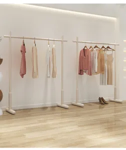 Detail view of minimalist floor-standing clothes rack with sturdy dual hanging rods.