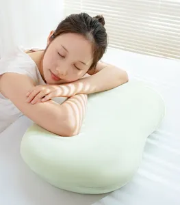 Ergonomic memory foam pillow detail view showing soft green cover and relaxing sleep position.