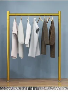 Detail view of the modern gold clothing rack showcasing clean minimalist hanging design for small spaces.