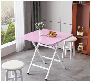 Minimalistische klaptafel met roze blad en witte poten, ideaal voor kleine woonruimtes thuis.