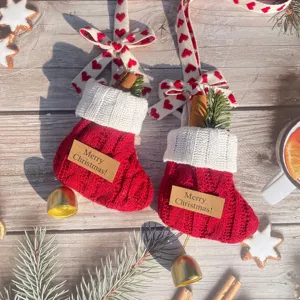 Mini Christmas stockings pendants with knit design, bells and pine twigs for holiday tree decor