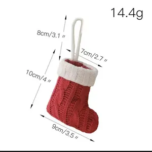 Detailed view of the red and white knitted Christmas stocking ornament with size specs.