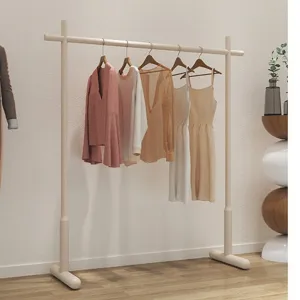 Minimalist floor-standing clothes rack for bedroom home organizing and garment storage.