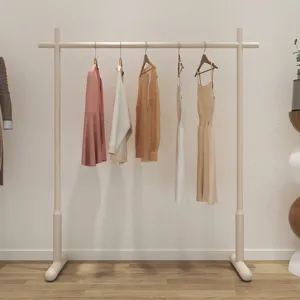 Modern minimalist floor standing clothes rack for bedroom and balcony, sturdy garment display rail.