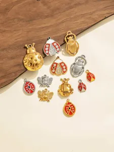 Close-up detail of retro insect charms pendants, including ladybug bee beetle DIY jewelry.