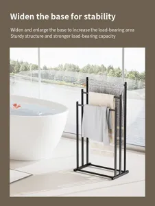 Detail view of the black metal freestanding towel rack placed in a modern bright bathroom.