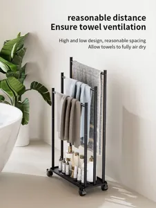 Close-up of floor-standing black metal towel rack with multiple tiers and bottom storage tray.